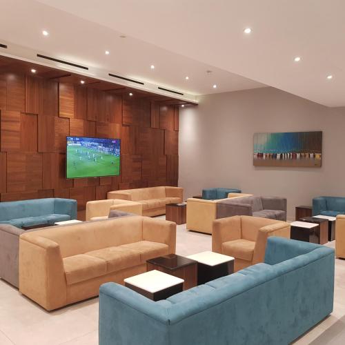 a living room with couches and a flat screen tv at Paradise Bay Resort in Mellieħa