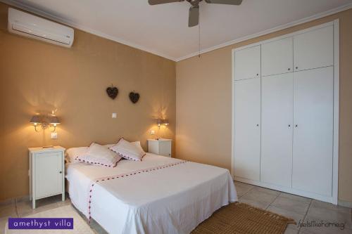 a bedroom with a white bed and a white closet at Afitos Hidden Gems #FeelsLikeHome in Afitos