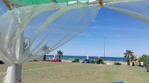 a white tent with the beach in the background at Villa Longo de Bellis in Bari