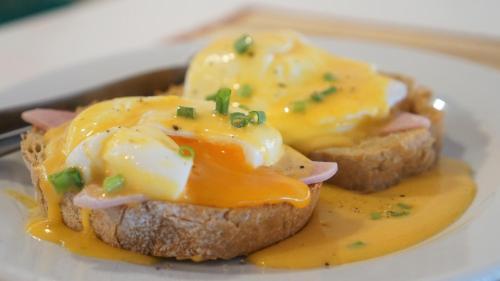 a sandwich with cheese and ham on a white plate at Morning Star Resort in Baan Tai