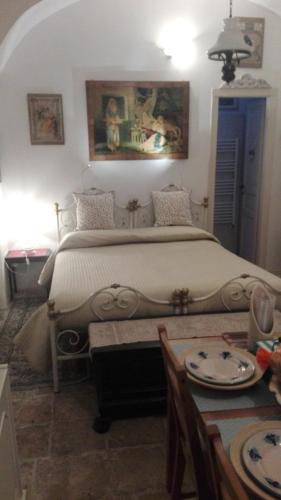a bedroom with a large bed and a table at Villa Longo de Bellis in Bari