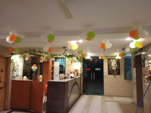 a room with balloons hanging from the ceiling at Hotel Apple Sai Residency in Shirdi