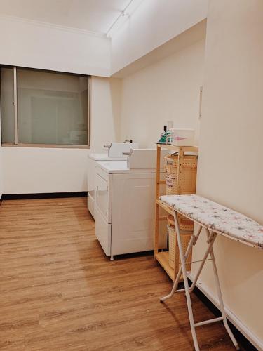 a kitchen with a counter and a sink and a table at Metro Hotel in Douliu