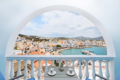 a balcony with a view of a harbor at Gorgona Blue Apartments in Karpathos Town