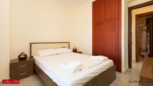 a bedroom with a bed with two towels on it at Afitos Hidden Gems #FeelsLikeHome in Afitos