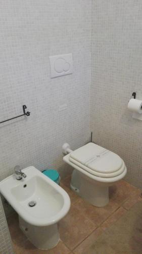 a bathroom with a toilet and a sink at Villa Longo de Bellis in Bari