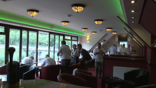 a group of people standing in a restaurant at Highland Getaway in Kinlochleven