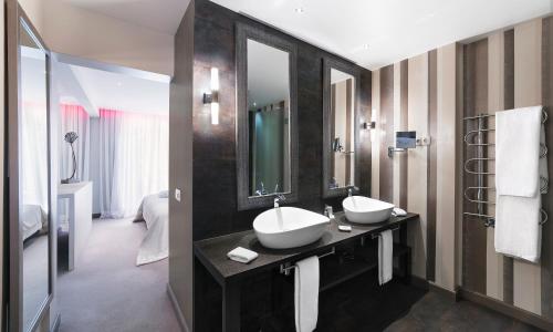 a bathroom with two sinks and a large mirror at Boutique Hotel Vivenda Miranda in Lagos