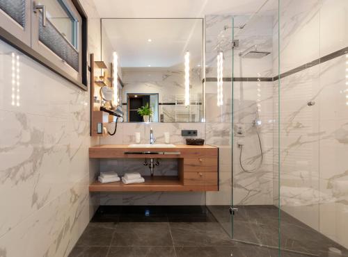 a bathroom with a sink and a glass shower at Rosenhof in Stetten