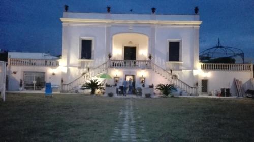 a large white building with a lighted at Villa Longo de Bellis in Bari