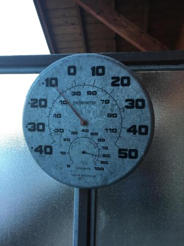 a clock on a wall with numbers on it at Les Ecureuils Squirrel Lodge in Oz