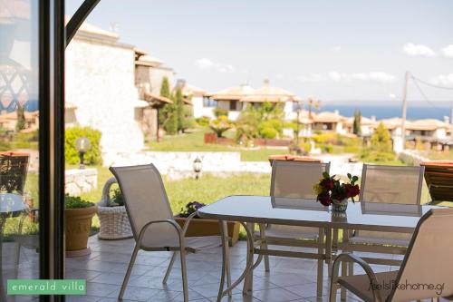 a table and chairs on a patio with a view at Afitos Hidden Gems #FeelsLikeHome in Afitos