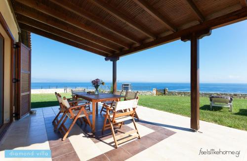 a patio with a table and chairs and the ocean at Afitos Hidden Gems #FeelsLikeHome in Afitos