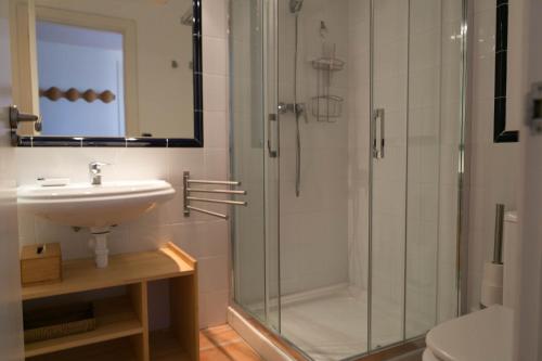 a bathroom with a shower and a sink at 2 bedroom apartment in Begur center. Sea views, terrace and pool (Ref:H09) in Begur