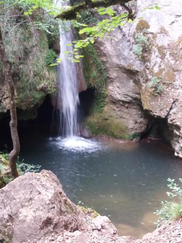 a waterfall next to a pool of water at La Casita del Río in Sabando