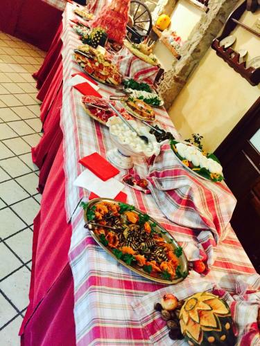 a long table with plates of food on it at Agriturismo Il Pozzo in Polla