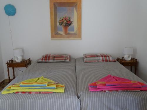 a bedroom with two beds with colorful towels on them at Alexandros House in Apollonia