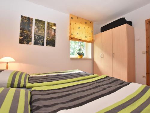 a bedroom with two beds and a cabinet at Farm holiday home in Damshagen with garden seating and sauna in Klütz