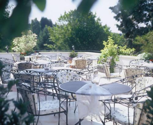 a group of tables and chairs sitting on a patio at Le Temple in NeuhÃ¼tten