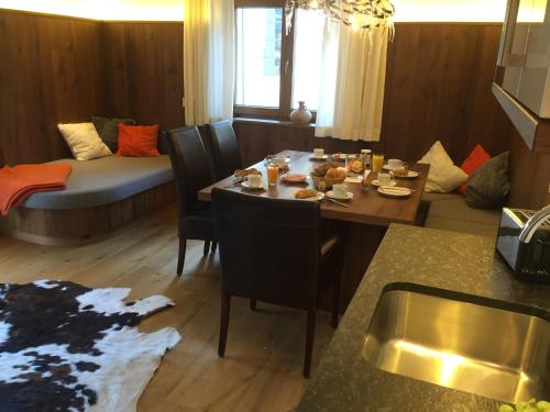 a living room with a table and chairs and a couch at Appartements Schweiberer in Ried im Zillertal