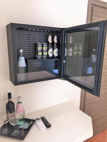 a refrigerator with bottles and glasses on a counter at Villa Emma Malcesine in Malcesine