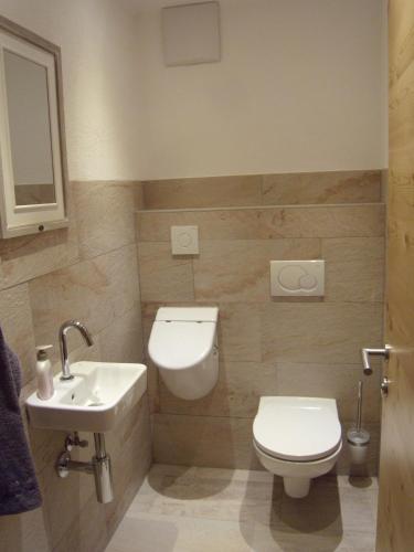 a bathroom with a toilet and a sink at Appartements Schweiberer in Ried im Zillertal
