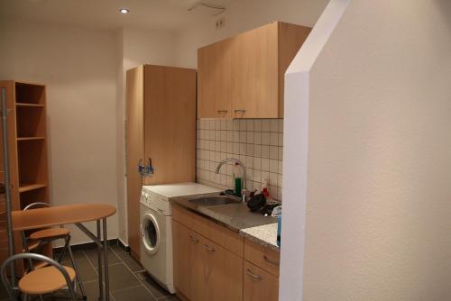 a kitchen with a sink and a washing machine at KAJÜTE in Brake