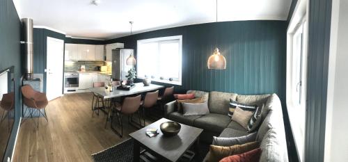 a living room with a couch and a table at Skarsnuten Apartments in Hemsedal