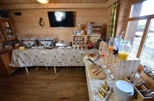 a room with a table with food and drinks on it at Hotel Köhlerhütte in Dresden
