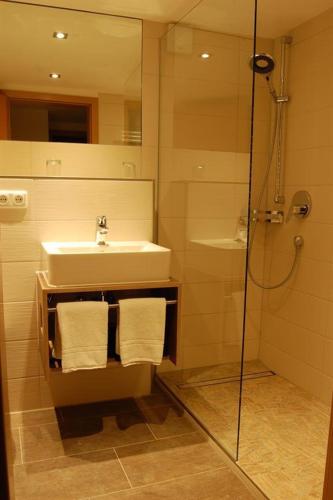 a bathroom with a sink and a shower at Haus Geiger in Bad Hindelang