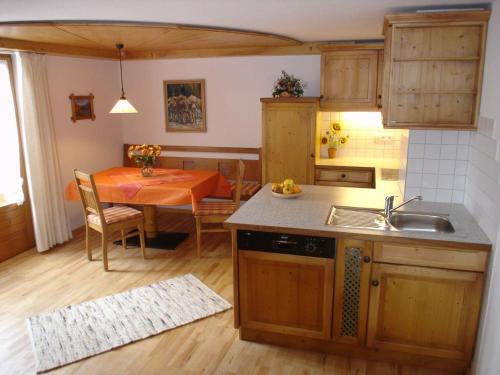 a kitchen and dining room with a table and a sink at Haus Geiger in Bad Hindelang