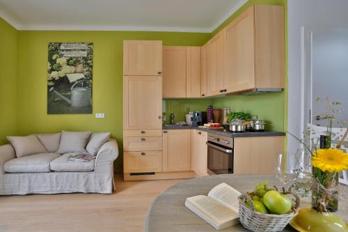a kitchen and living room with a couch and a table at Landvilla Pia in Attendorf