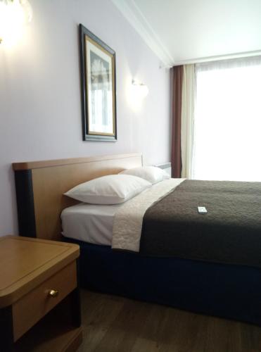 a hotel room with a bed and a window at SKY&KTS Apartments in Boryspilʼ