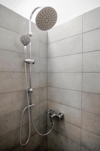 a shower with a shower head in a bathroom at Pop Art Hostel in Lviv