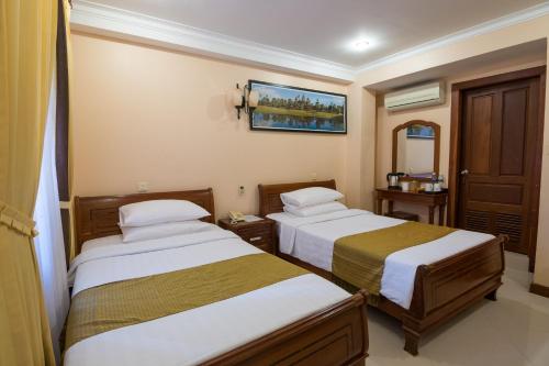 Un ou plusieurs lits dans un hébergement de l'établissement Neth Socheata Hotel