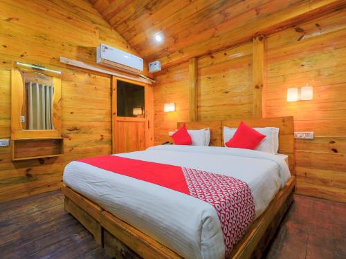 a bedroom with a bed in a wooden room at Brushwood Villa- Cottages and Bar in Palolem