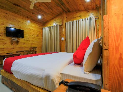 a bedroom with a bed in a wooden cabin at Brushwood Villa- Cottages and Bar in Palolem