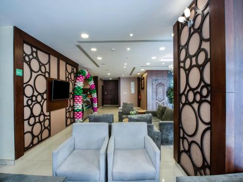 a lobby with two chairs and a waiting room at Open Hotel Alolaya in Al Khobar
