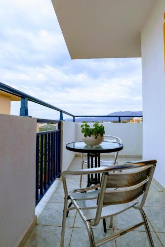 a balcony with a table and chairs on a balcony at Eltina Apartments in Malia