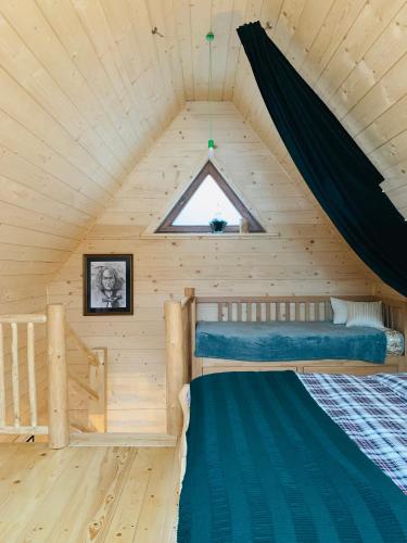 a bedroom in a wooden cabin with two bunk beds at Dadejówka Zakopane in Zakopane