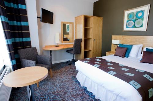 a hotel room with a bed and a desk at Best Western Plus Nottingham Westminster Hotel in Nottingham