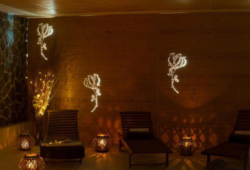a room with two chairs and lights on the wall at Dixon Resort in Banská Bystrica