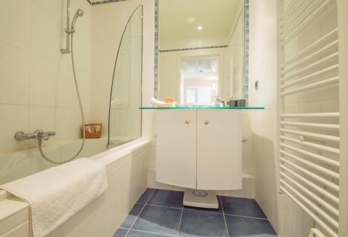 a bathroom with a shower and a sink and a mirror at Sunlight Properties - "Kahlua" - Cannes - Sea front in Cannes