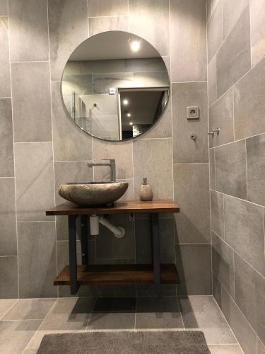 a bathroom with a sink and a mirror at Fjällhem in Sälen