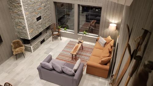 a living room with a couch and a fireplace at Fjällhem in Sälen
