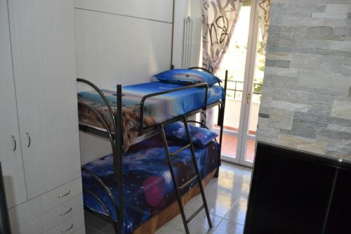 a room with three bunk beds in a room at Appartamenti Lago di Como in Valbrona