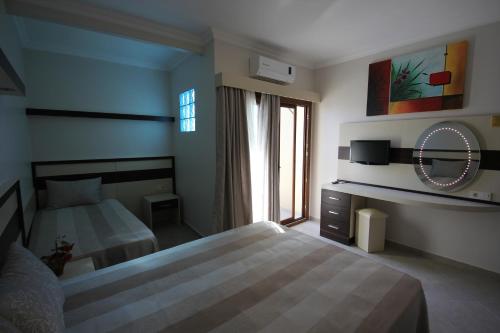 Ένα ή περισσότερα κρεβάτια σε δωμάτιο στο Amfora Hotel