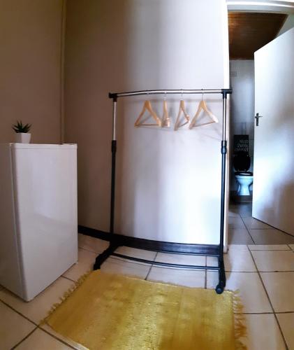 a kitchen with a white refrigerator and a tile floor at Lush in Graskop
