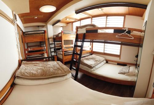 two bunk beds in a small room in a house at Nono teru Narita in Narita