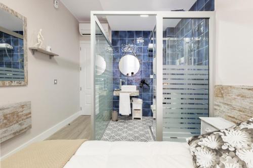 a bedroom with a king sized bed and a bathroom at Urban Sabadell in Sabadell